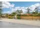 Home exterior with a wooden fence and colorful landscaping at 5780 Elton Rd, Venice, FL 34293