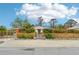 Cute yellow house with attractive landscaping and a wood fence at 5780 Elton Rd, Venice, FL 34293