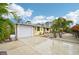 Yellow house with white garage door and landscaping at 5780 Elton Rd, Venice, FL 34293