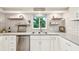 Modern kitchen with gray countertops and white cabinets at 5780 Elton Rd, Venice, FL 34293