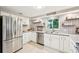 Modern kitchen with stainless steel appliances and gray countertops at 5780 Elton Rd, Venice, FL 34293