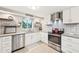 Modern kitchen with stainless steel appliances and gray countertops at 5780 Elton Rd, Venice, FL 34293