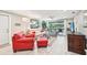 Living room with red and grey seating and a view of the kitchen at 5780 Elton Rd, Venice, FL 34293