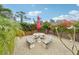 Relaxing backyard patio with mosaic table and benches, perfect for outdoor dining at 5780 Elton Rd, Venice, FL 34293