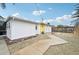 Side yard with concrete pathway and gravel at 5780 Elton Rd, Venice, FL 34293