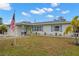 Charming single story home with a manicured lawn and American flag at 5871 49Th N Ave, Kenneth City, FL 33709