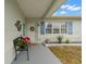 Inviting front porch with a bench and colorful flowers at 5871 49Th N Ave, Kenneth City, FL 33709