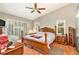 Spacious main bedroom with wood furniture and access to patio at 6009 County Line Rd, Spring Hill, FL 34606