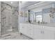 Elegant bathroom with double vanity, large shower, and marble tile at 6224 Vista Verde W Dr, St Petersburg, FL 33707