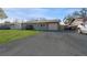 Front view of a ranch home with a driveway and carport at 6512 2Nd Ave Ne, Bradenton, FL 34208