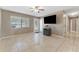 Bright living room with tile floors and a large TV at 6512 2Nd Ave Ne, Bradenton, FL 34208