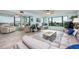 Bright living room with light floors, comfy seating and water views at 750 Island Way # 401, Clearwater Beach, FL 33767