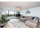 Spacious living room featuring light walls, ample seating, and large windows at 750 Island Way # 401, Clearwater Beach, FL 33767