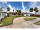 Home with a circular driveway, palm trees, and a white mailbox at 809 Mandalay Ave, Clearwater Beach, FL 33767