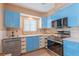 Newly remodeled kitchen with blue cabinets and stainless steel appliances at 809 Mandalay Ave, Clearwater Beach, FL 33767