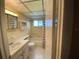 Bathroom with bathtub, toilet, and vanity with sink at 8525 111Th St # 205, Seminole, FL 33772