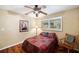 Cozy bedroom featuring a ceiling fan and wood flooring at 9923 119Th Way, Seminole, FL 33772