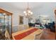 Bright dining room with a wooden table and chandelier, adjacent to the living room at 9923 119Th Way, Seminole, FL 33772