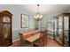 Dining room with hardwood floors, chandelier, and display cabinet at 9923 119Th Way, Seminole, FL 33772