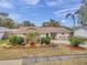 Single-story home with landscaped yard and driveway at 9923 119Th Way, Seminole, FL 33772