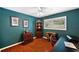 Home office with teal walls and wood floors at 9923 119Th Way, Seminole, FL 33772