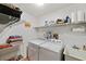 Laundry room with washer, dryer, shelving, and utility sink at 9923 119Th Way, Seminole, FL 33772