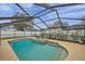 Enclosed pool area with a spa and a spacious deck at 9923 119Th Way, Seminole, FL 33772