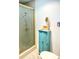 Bathroom with shower and small storage cabinet at 102 Cambridge Trl # 229, Sun City Center, FL 33573