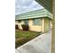 Building exterior showcasing a light yellow facade and green roof at 102 Cambridge Trl # 229, Sun City Center, FL 33573