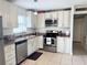 Modern kitchen featuring white cabinets and stainless steel appliances at 102 Cambridge Trl # 229, Sun City Center, FL 33573