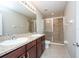 Double vanity bathroom with a walk-in shower at 10415 Butterfly Wing Ct, Riverview, FL 33578