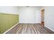 Bedroom with wood-look flooring and an accent wall at 10415 Butterfly Wing Ct, Riverview, FL 33578