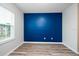 Bedroom with a blue accent wall and wood-look floors at 10415 Butterfly Wing Ct, Riverview, FL 33578