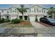 Three-unit townhome building with attached garages and landscaping at 10415 Butterfly Wing Ct, Riverview, FL 33578