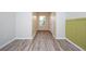 Bright hallway with wood-look flooring and neutral walls at 10415 Butterfly Wing Ct, Riverview, FL 33578