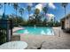 Inviting community pool with lounge chairs and patio tables at 10415 Butterfly Wing Ct, Riverview, FL 33578