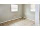 Bedroom with neutral walls, tile floors, and window with blinds at 10591 116Th Ter, Largo, FL 33773