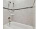 Bathroom with shower and tub, tiled walls, and double shower heads at 10825 Charmwood Dr, Riverview, FL 33569