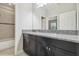 Double vanity bathroom with granite countertop and large mirror at 10825 Charmwood Dr, Riverview, FL 33569