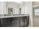 Bathroom features granite countertop, dark cabinets, and a large mirror at 10825 Charmwood Dr, Riverview, FL 33569