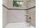 Clean bathroom with tiled shower and tub at 10825 Charmwood Dr, Riverview, FL 33569