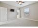 Spacious bedroom with wall-mounted TV and ceiling fan at 10825 Charmwood Dr, Riverview, FL 33569