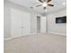 Bright bedroom with double doors and wall-mounted TV at 10825 Charmwood Dr, Riverview, FL 33569