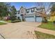 Two-story house with stone and blue siding, three-car garage, and driveway at 10825 Charmwood Dr, Riverview, FL 33569