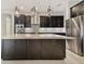 Modern kitchen with dark cabinetry, stainless steel appliances and large island at 10825 Charmwood Dr, Riverview, FL 33569