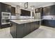 Modern kitchen with dark cabinetry, stainless steel appliances, and large island at 10825 Charmwood Dr, Riverview, FL 33569