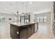 Kitchen island with seating space and modern pendant lighting at 10825 Charmwood Dr, Riverview, FL 33569