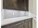 White quartz countertop and dark brown cabinets at 10825 Charmwood Dr, Riverview, FL 33569