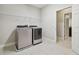 Laundry room with washer, dryer, and access to a bathroom at 10825 Charmwood Dr, Riverview, FL 33569