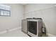 Laundry room with washer, dryer, and overhead shelving at 10825 Charmwood Dr, Riverview, FL 33569